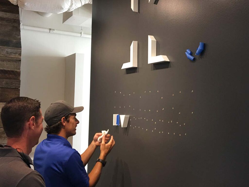 installng company logo to interior wall