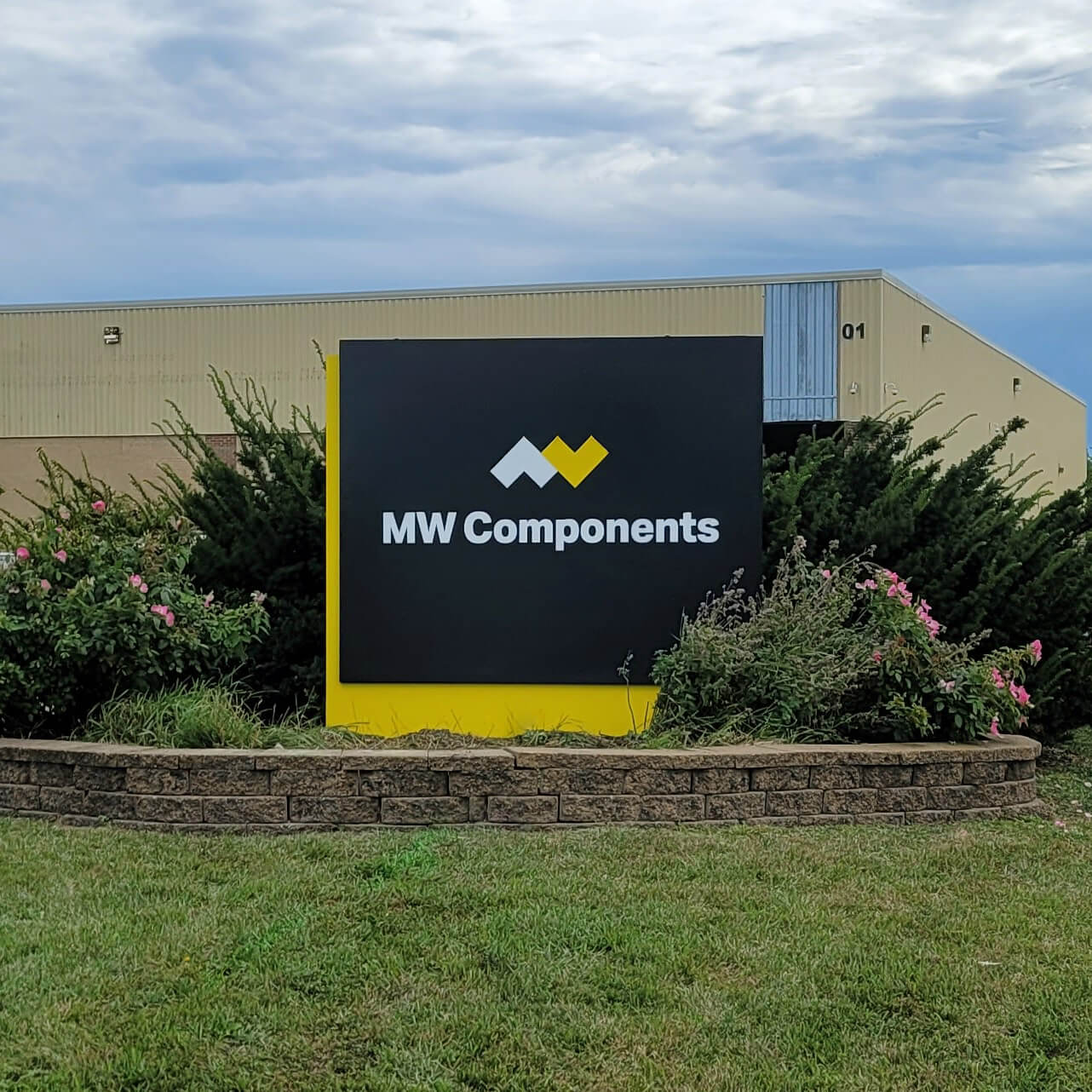 Monument Monument sign reading "MW Components"