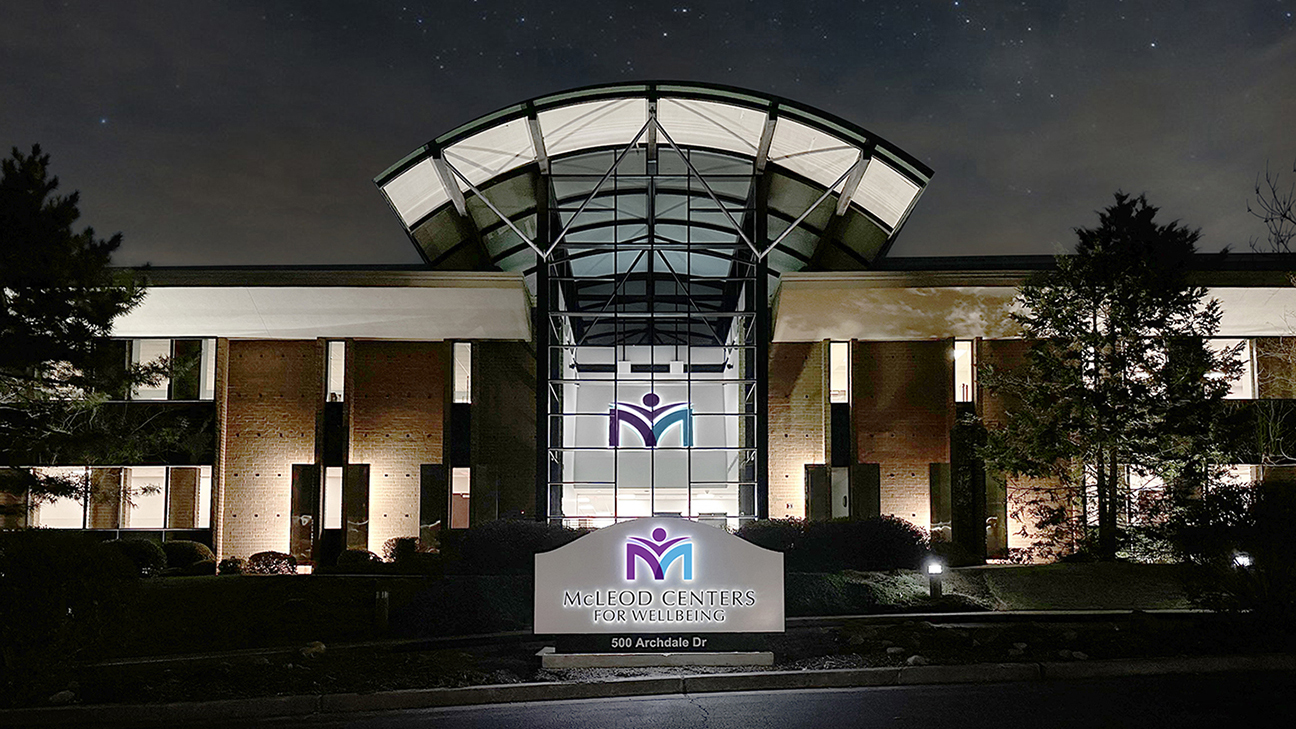 Nighttime view of signage at McLeod Monument
